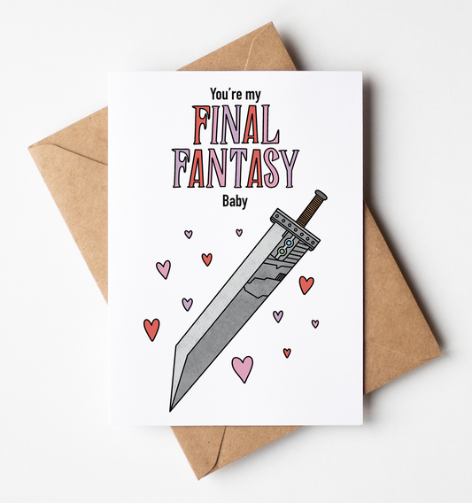 A white greeting card with a sword and heart illustration and the text 'You're my Final Fantasy Baby', placed on top of a brown kraft envelope against a light gray background.