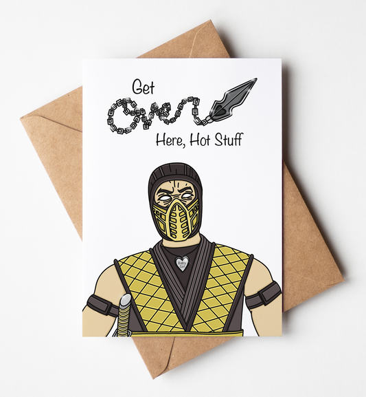 A white greeting card with a brown kraft envelope behind it, featuring a cartoon illustration of a masked figure in a yellow and black diamond-patterned outfit and the text 'Get Over Here, Hot Stuff'.