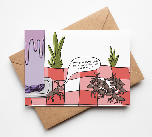 A square illustrated greeting card with a brown kraft envelope behind it, photographed on a clean white background. The card shows a cartoon scene with ants on a pink-and-white checkered surface, a purple wall, and a speech bubble reading, 'how you doing eh? no time for my birthday!!'.