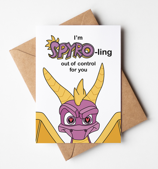 A white greeting card featuring a cartoon illustration of a purple dragon with yellow horns and the text 'I'm SPYRO-ling out of control for you', shown with a brown kraft envelope on a light gray background.